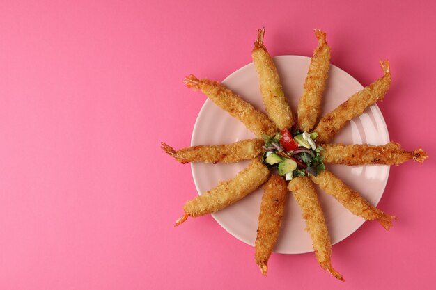 ÃÂ¡oncept of tasty food with deep-fried shrimp on pink background