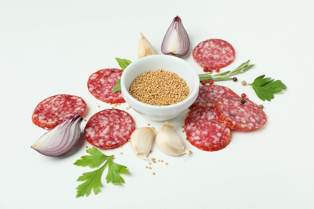 ÃÂ¡oncept of tasty food with salami sausage on white background