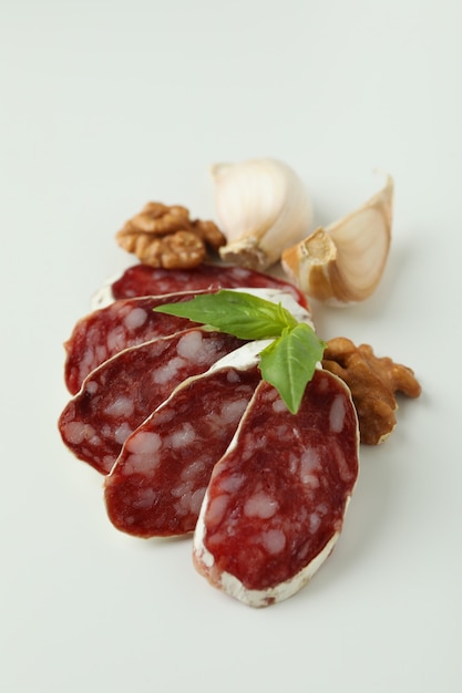 ÃÂ¡oncept of tasty food with salami sausage on white background