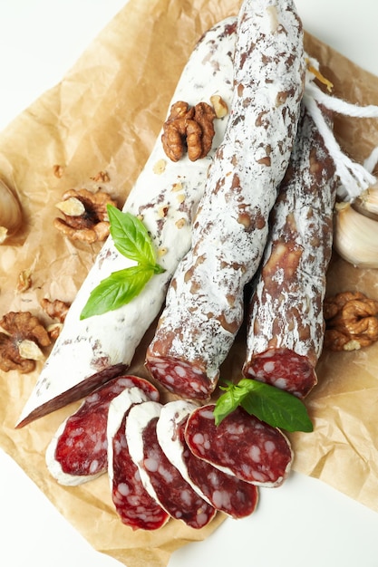 ÃÂÃÂ¡oncept of tasty food with salami sausage on white background