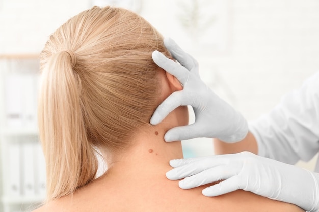 oncologist examining female patient in clinic cancer awareness