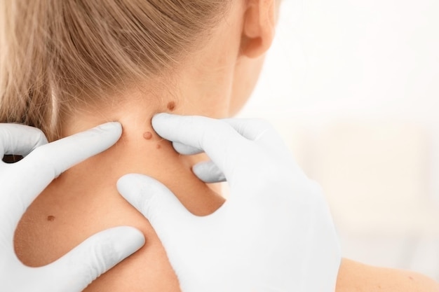 oncologist examining female patient in clinic cancer awareness