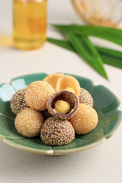 Onde-onde or Glutinous Rice Sesame Seed Ball, Served on Indonesian Traditional Style Bali Plate. Close Up. Popular Indonesian Snack with Chinese Influence