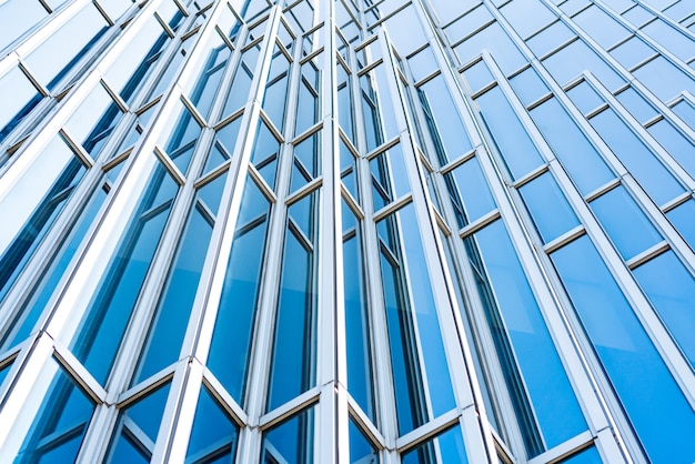Onderkant panoramisch en perspectief uitzicht op staalblauwe glazen hoogbouw wolkenkrabbers, bedrijfsconcept van succesvolle industriële architectuur