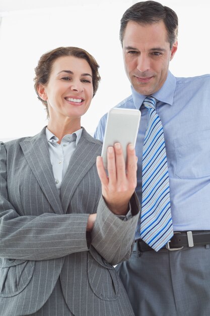 Foto onderneemster die iets toont aan haar collega op haar smartphone