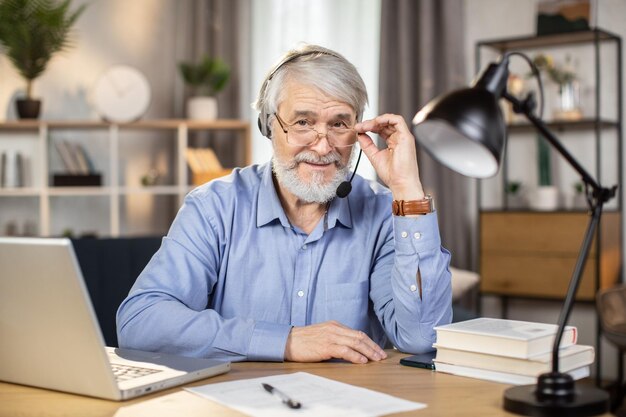 Ondernemer die over een bril tuurt aan een bureau met gadgets