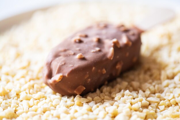 One almond chocolate icecream on a stick Close up