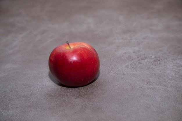 one apple on the wooden background