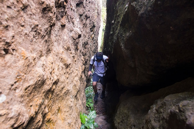 One backpacker man travel alone, with backpack in the mountains