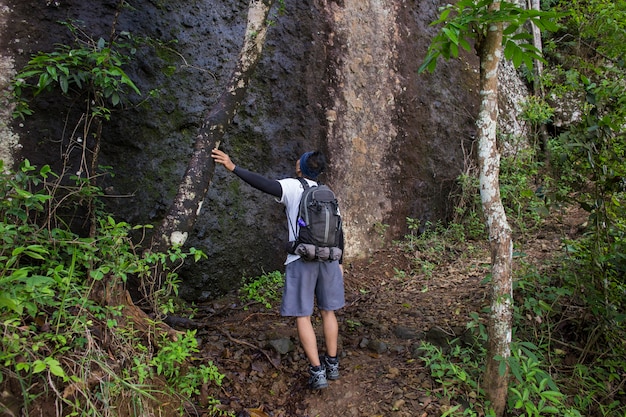 One backpacker man travel alone, with backpack in the mountains