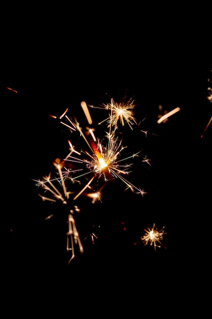 One bengal fire sparkles against the black background.