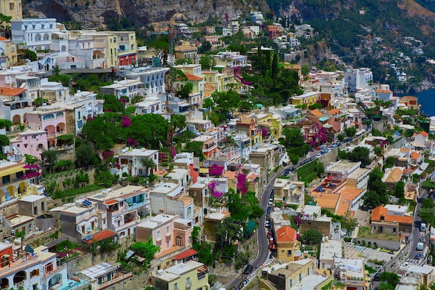 One of the best resorts of Italy with old colorful villas on the steep slope nice beach numerous yachts and boats in harbor and medieval towers along the coast Positano