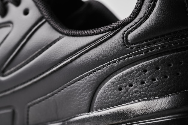 One black leather men's sneaker closeup details
