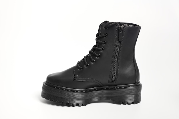 One black women combat boot on high heel platform with lug sole\
on isolated white background