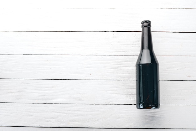 One bottle of beer on a wooden background Free space for text Top view