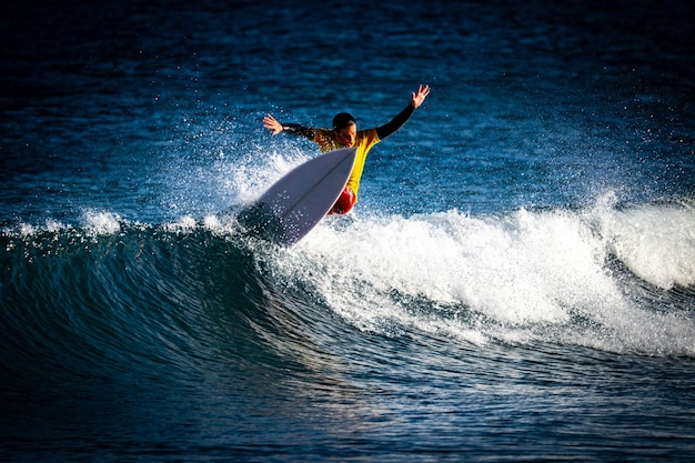 One boy surfing alone and training hard to tournament and championships - active and fitness man lifestyle and concept