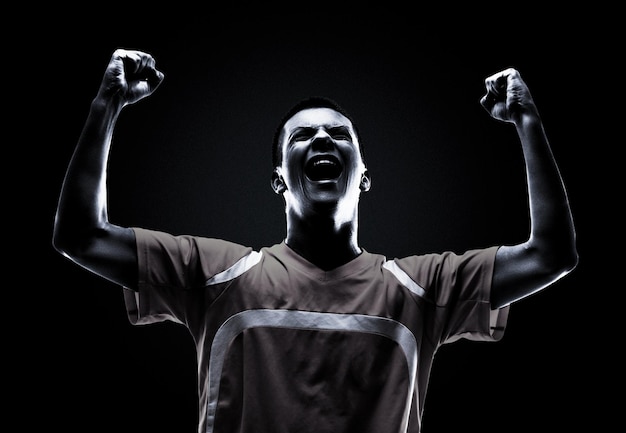 one brazilian soccer football player young man happiness joy pointing up  in silhouette studio