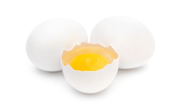 One broken egg with two whole eggs on white background