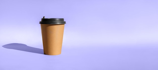 One Brown coffee paper cup Mockup with lid Set of craft paper cups for coffee or tea on violet
