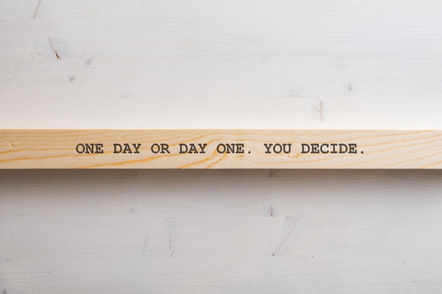 One day or day one You decide sign written on a wooden slat