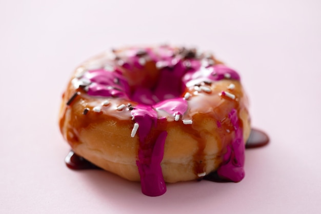 one donut with jam on pink paper