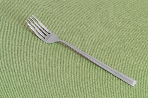 One fork on a green sheet