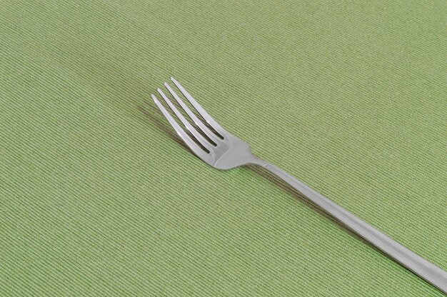 One fork on a green sheet