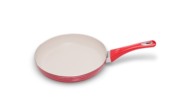 One frying pan of red color on a white background closeup