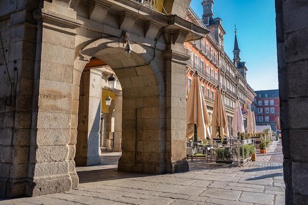 One of the gateways to the main square of Madrid with its typical old buildings around the square Spain