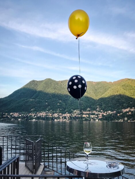 One glass wine with ballon on the mountain and river background cernobbio