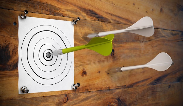 One green dart hitting the center of a hand made target fixed by 4 thumbtacks onto a wooden wall