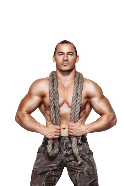 One handsome sexual strong young man muscular body holding rope with hands hanging on neck and shoulders standing posing in studio on white background