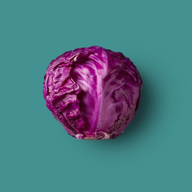 Photo one head of raw red cabbage presented on a green background,vegetable. from color cabbage series