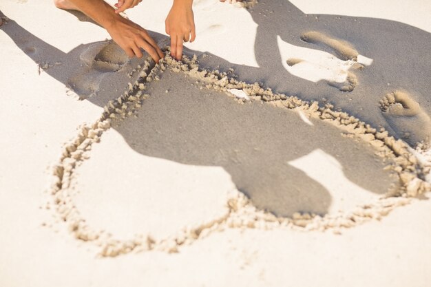 one heart drawn in the sand 