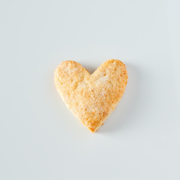 One heart shaped cookie on a white background