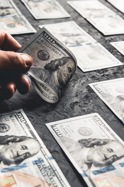 One hundred dollar bills are creatively laid out. beautiful\
original cash flow. one hundred bucks as a background on a long\
banner in high resolution. business concept, development\
perspective.