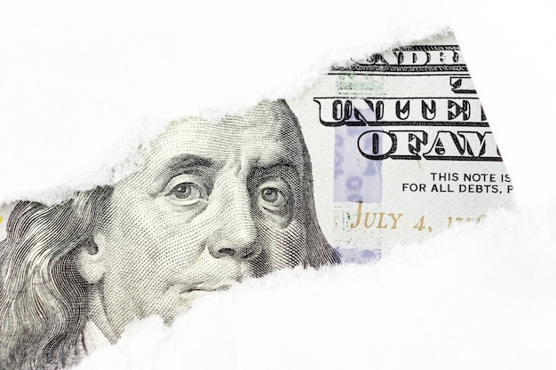 One hundred dollars bill fragment Benjamin Franklin portrait on 100 banknote in torn paper hole New sample money