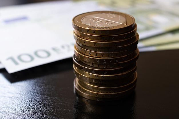 One hundred euro bills and coins closeup