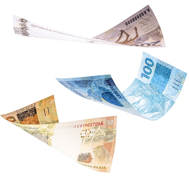 Photo one hundred, fifty and two hundred reais bills falling on isolated white background