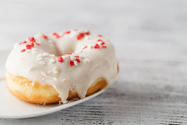 One iced donut with heart decoration