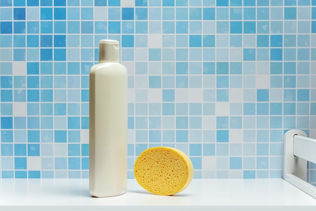 One liter bottle of shampoo with a yellow synthetic sponge on a white bathroom cabinet