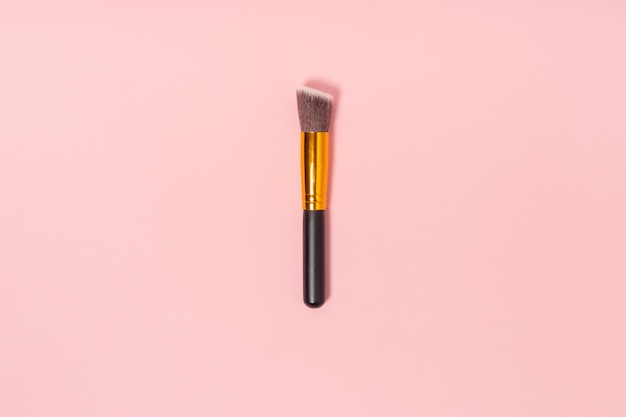 One makeup or facial brush isolated on a pink background