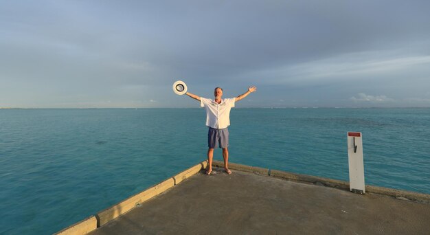 one man on a tropical island with white sand in the ocean