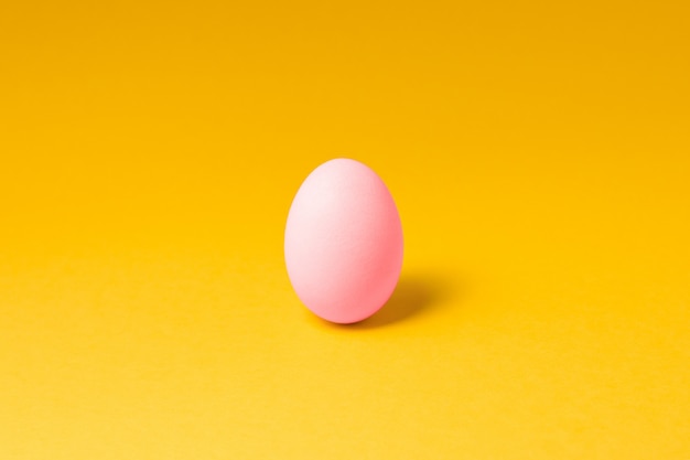 One pastel pink color egg in center Easter decoration. easter concept design