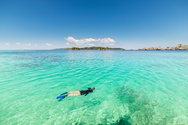 One person snorkeling in turquoise transparent water, Sulawesi Indonesia