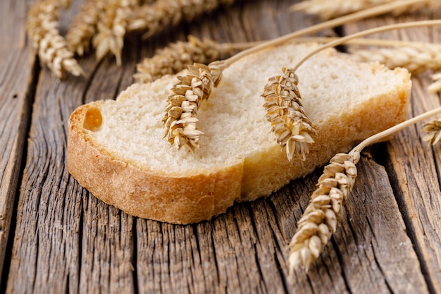 One piece of bread on wooden table