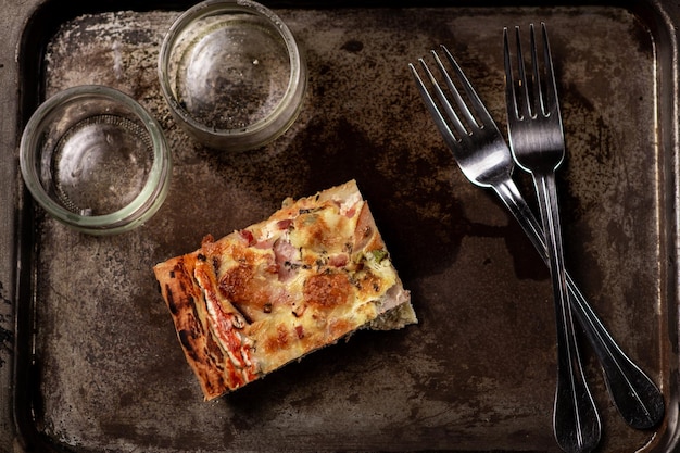 Photo one piece of pizza on an old tray last piece diet food restriction concept