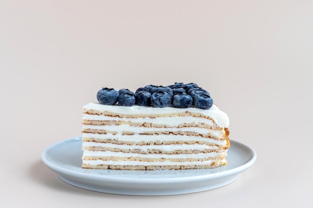 One piece of vanilla gluten free crepe cake with blueberries closeup