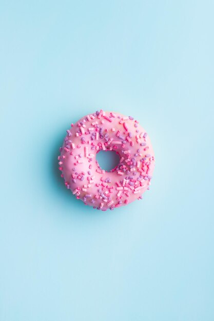 One pink donut on blue background