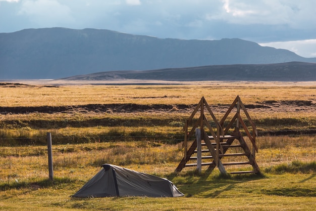 One pitch tent in a beautiful campsite in Iceland near a staircase